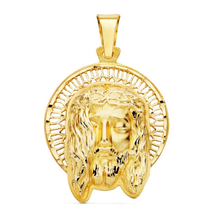 Colgante de oro amarillo de 18 quilates con el rostro de Cristo y una orla ornamental a su alrededor, tamaño 29x25 mm.
